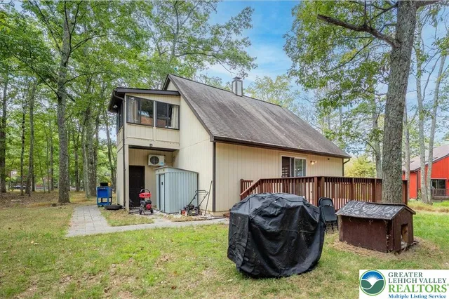 a view of house with backyard and furniture