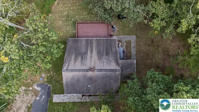 an outdoor space with seating area and trees