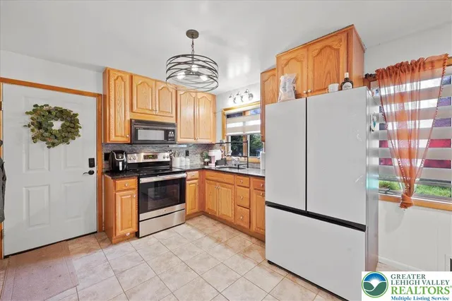 a kitchen with stainless steel appliances a refrigerator sink and cabinets