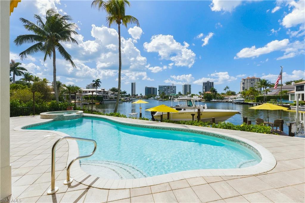 361 Pirates Bight Naples, FL 34103 - Photo 40 of 45 a view of a swimming pool with outdoor seating