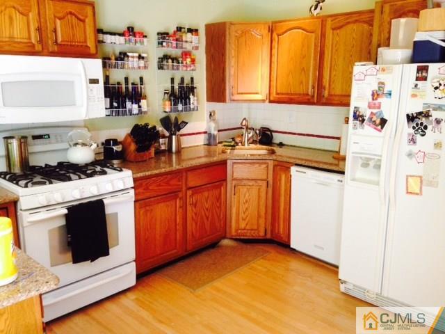75 Rieder Road Spotswood, NJ 08884 - Photo 7 of 15 a kitchen with stainless steel appliances granite countertop a stove a sink and a microwave