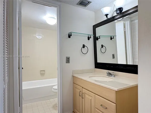 a bathroom with a sink a vanity and a mirror