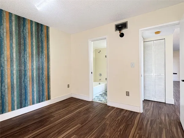 a view of a room with wooden floor