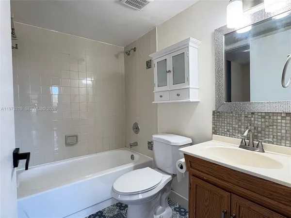 a bathroom with a sink a toilet and a bathtub