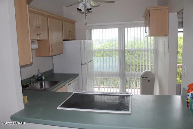 a kitchen with a large window and stainless steel appliances