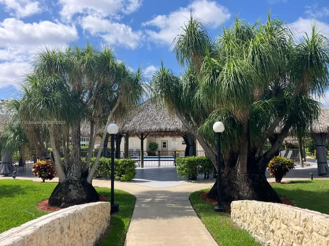 a front view of a house with a yard table and chairs