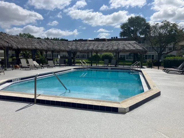 a view of a swimming pool with outdoor seating