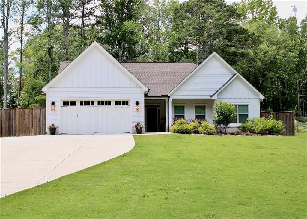 a view of house with yard and outdoor seating