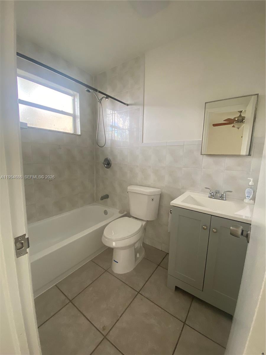 11350 Southwest 3rd Street, Unit A Sweetwater, FL 33174 - Photo 13 of 18 a bathroom with a sink toilet and shower