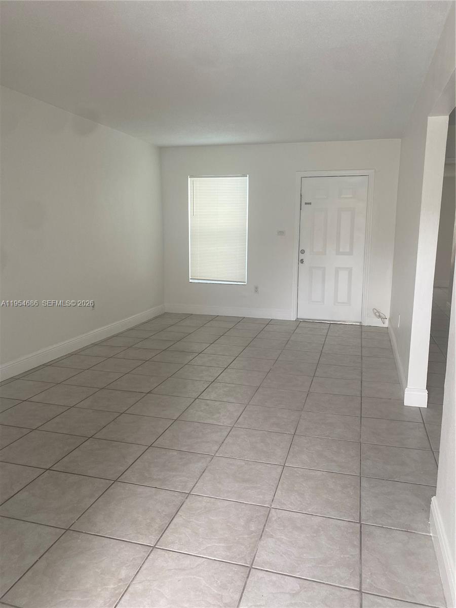 11350 Southwest 3rd Street, Unit A Sweetwater, FL 33174 - Photo 3 of 18 a view of an empty room with a window