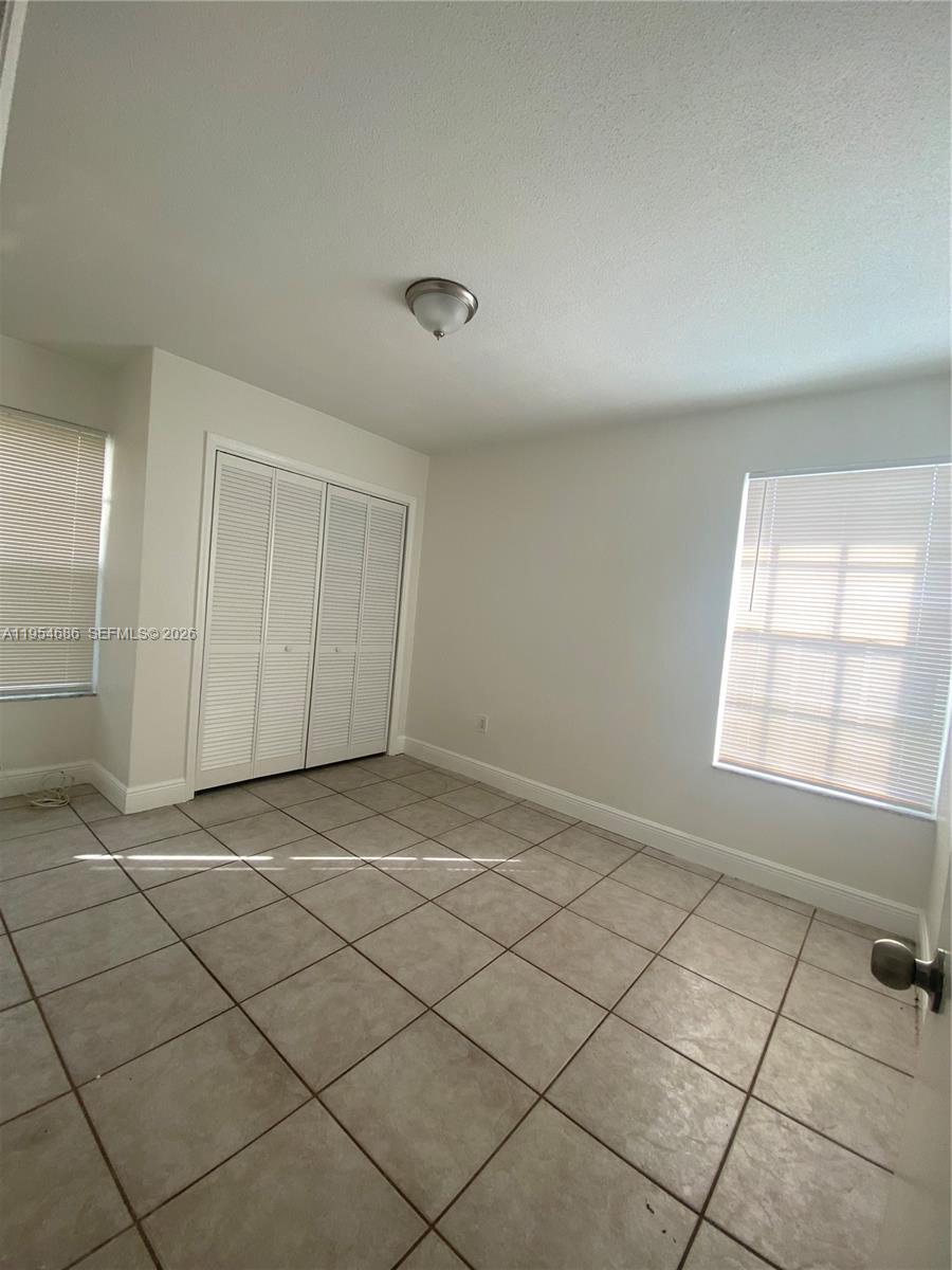 11350 Southwest 3rd Street, Unit A Sweetwater, FL 33174 - Photo 8 of 18 en empty room with a window