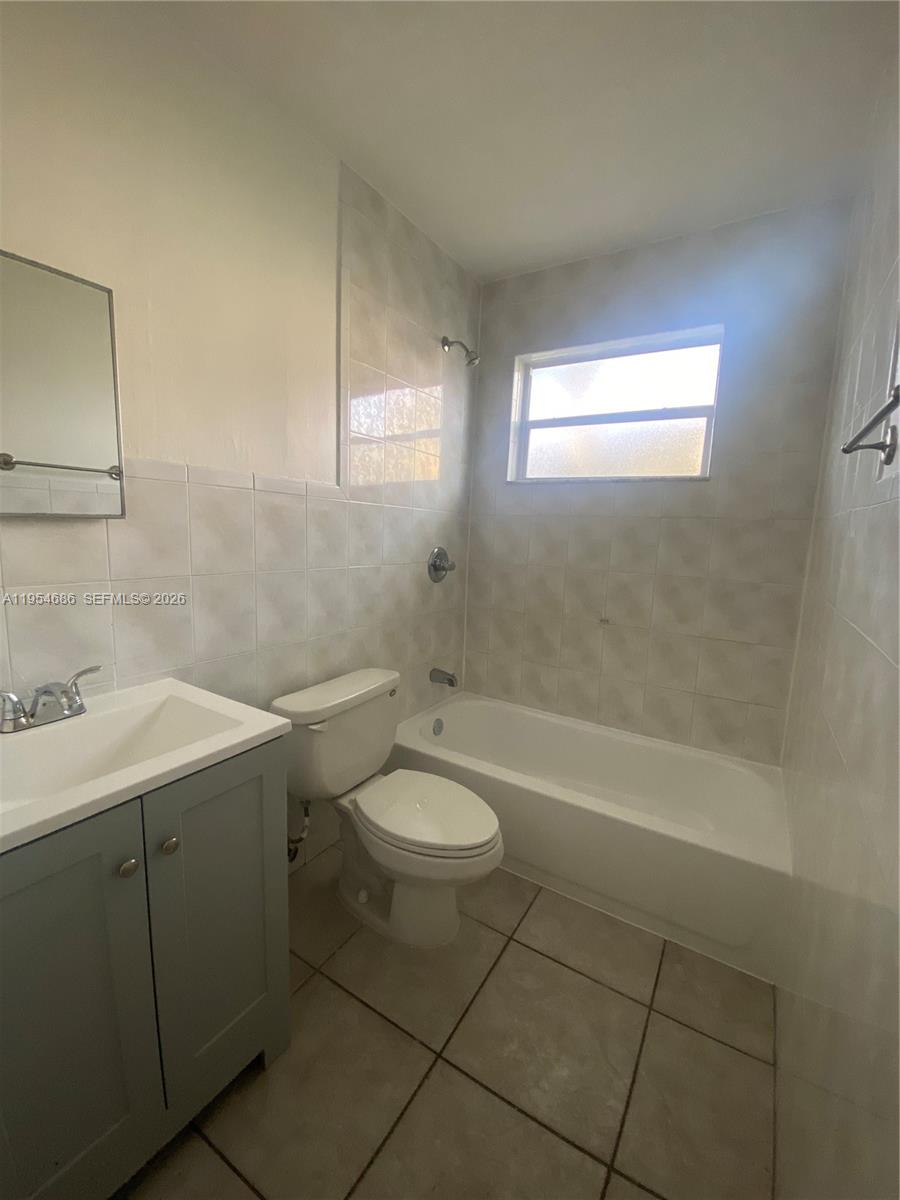 11350 Southwest 3rd Street, Unit A Sweetwater, FL 33174 - Photo 10 of 18 a bathroom with a sink a toilet and shower
