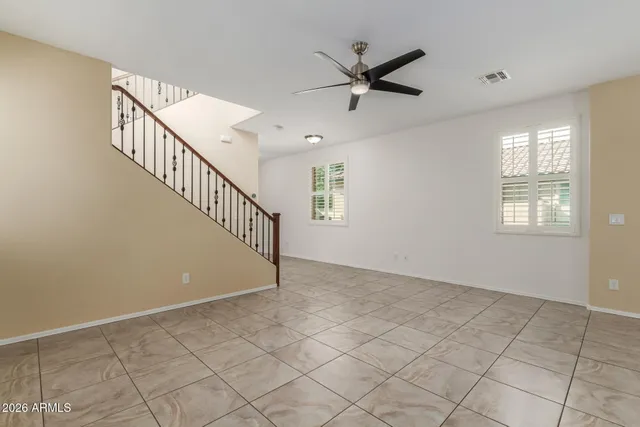 a view of a livingroom with a ceiling fan and window
