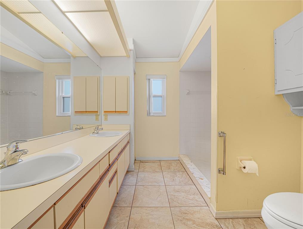 6011 Condor Drive Lakeland, FL 33809 - Photo 14 of 26 a bathroom with a sink a toilet and tub