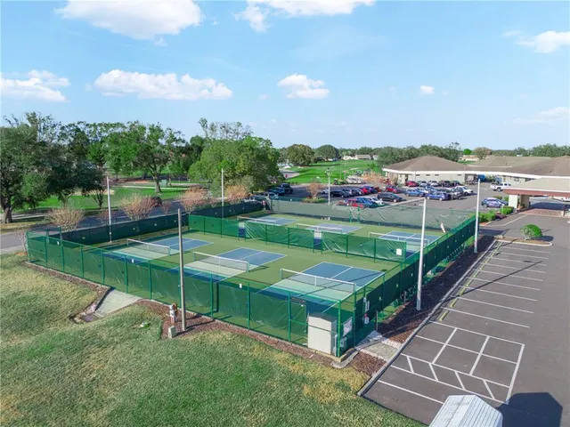 an aerial view of a house with a garden and lake view