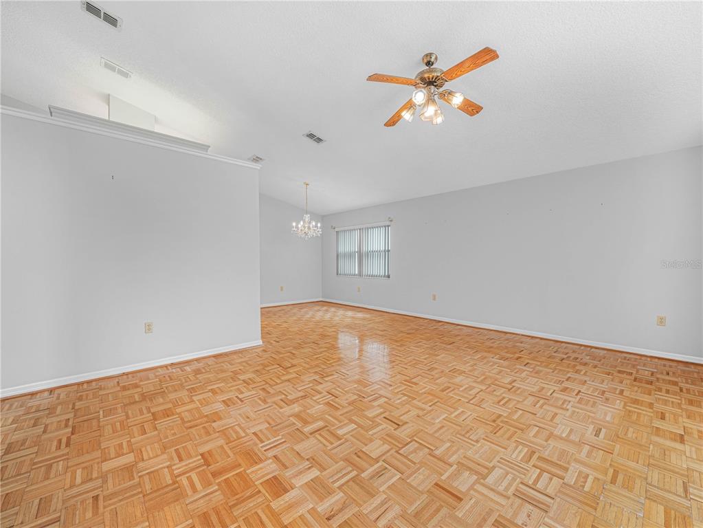 6011 Condor Drive Lakeland, FL 33809 - Photo 5 of 26 an empty room with a ceiling fan and window