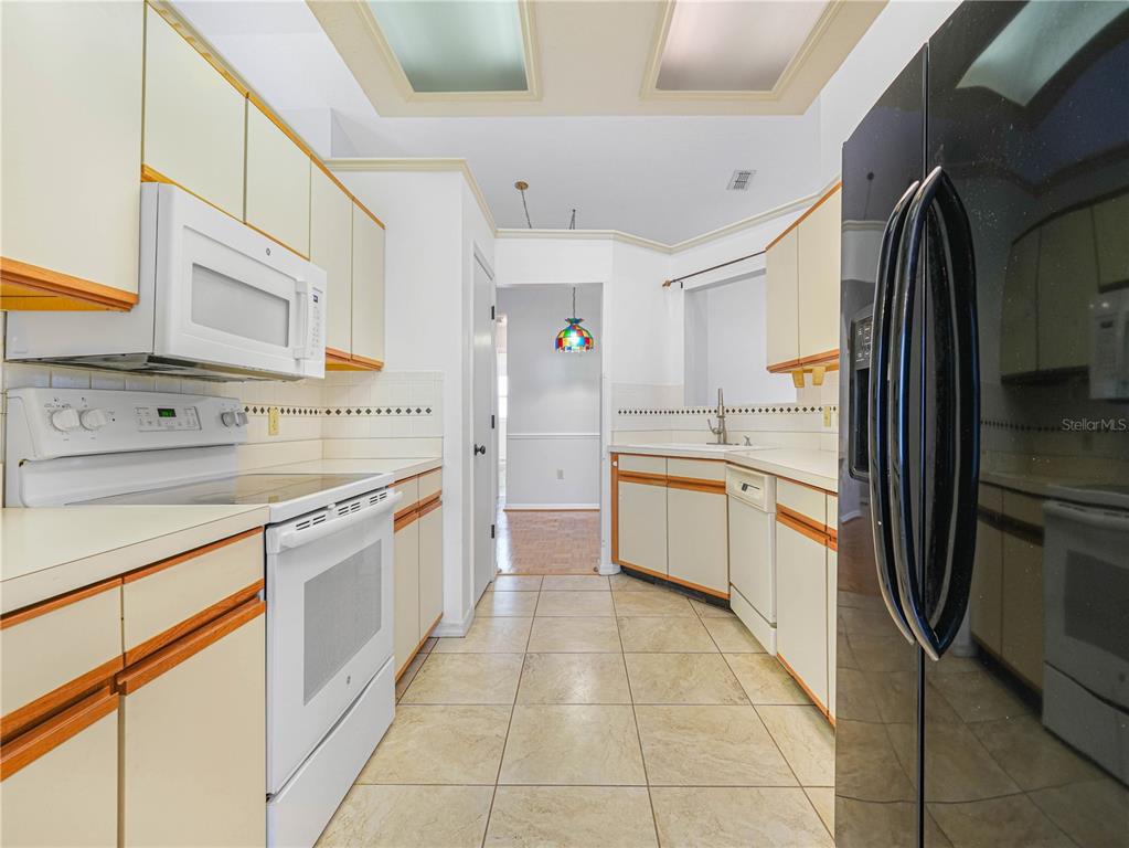 6011 Condor Drive Lakeland, FL 33809 - Photo 7 of 26 a kitchen with stainless steel appliances granite countertop a refrigerator and a sink