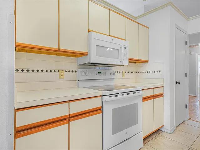 a kitchen with stainless steel appliances granite countertop white cabinets and a sink