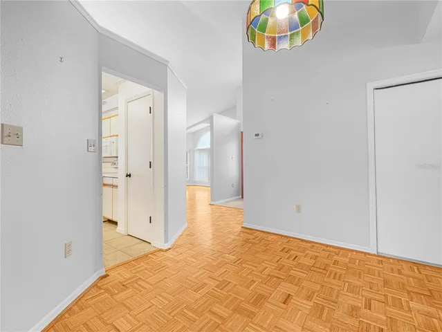 a view of a room with wooden floor and window