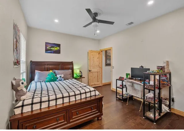 a bedroom with a bed and a desk