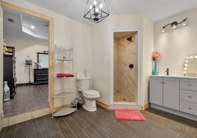 a bathroom with a sink toilet and shower