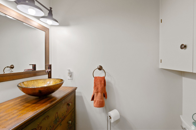 1900 North 100 East Provo, UT 84604 - Photo 21 of 49 Vessel sink with a bronze-toned basin atop a wood-finish vanity with decorative detailing