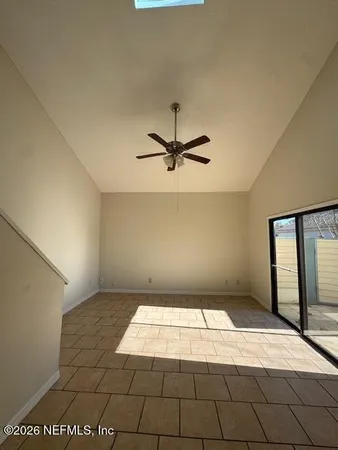 a view of a livingroom with a ceiling fan and window