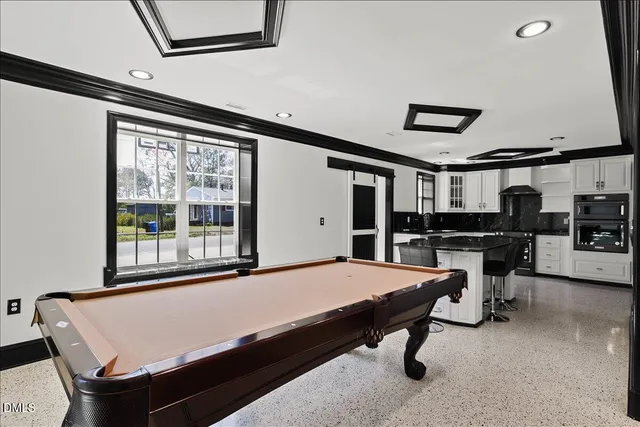 a room with chairs and pool table
