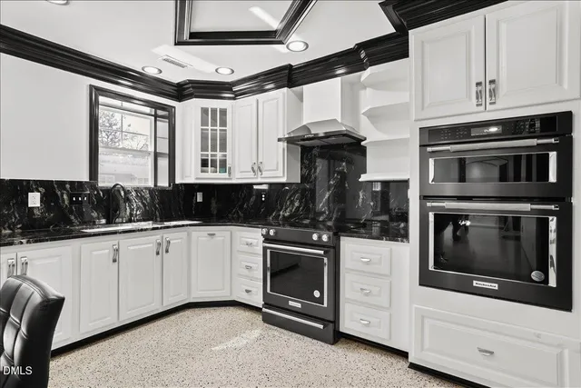 a kitchen with white cabinets and appliances