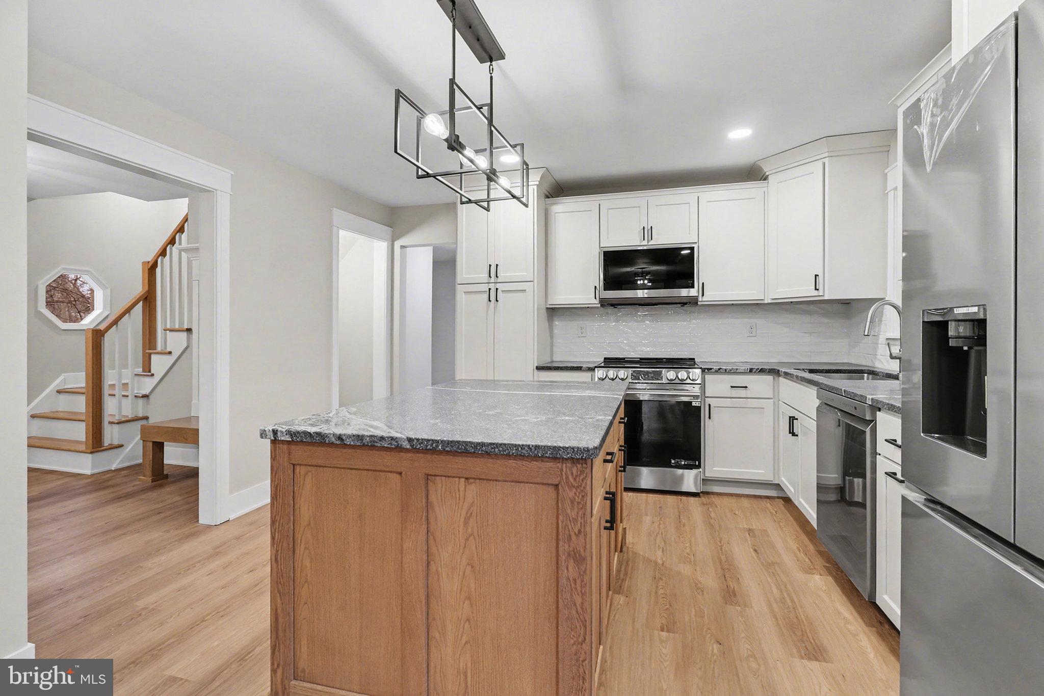 626 Sand Hill Road Hershey, PA 17033 - Photo 11 of 29 a kitchen with kitchen island granite countertop a stove a sink a refrigerator and a granite counter top