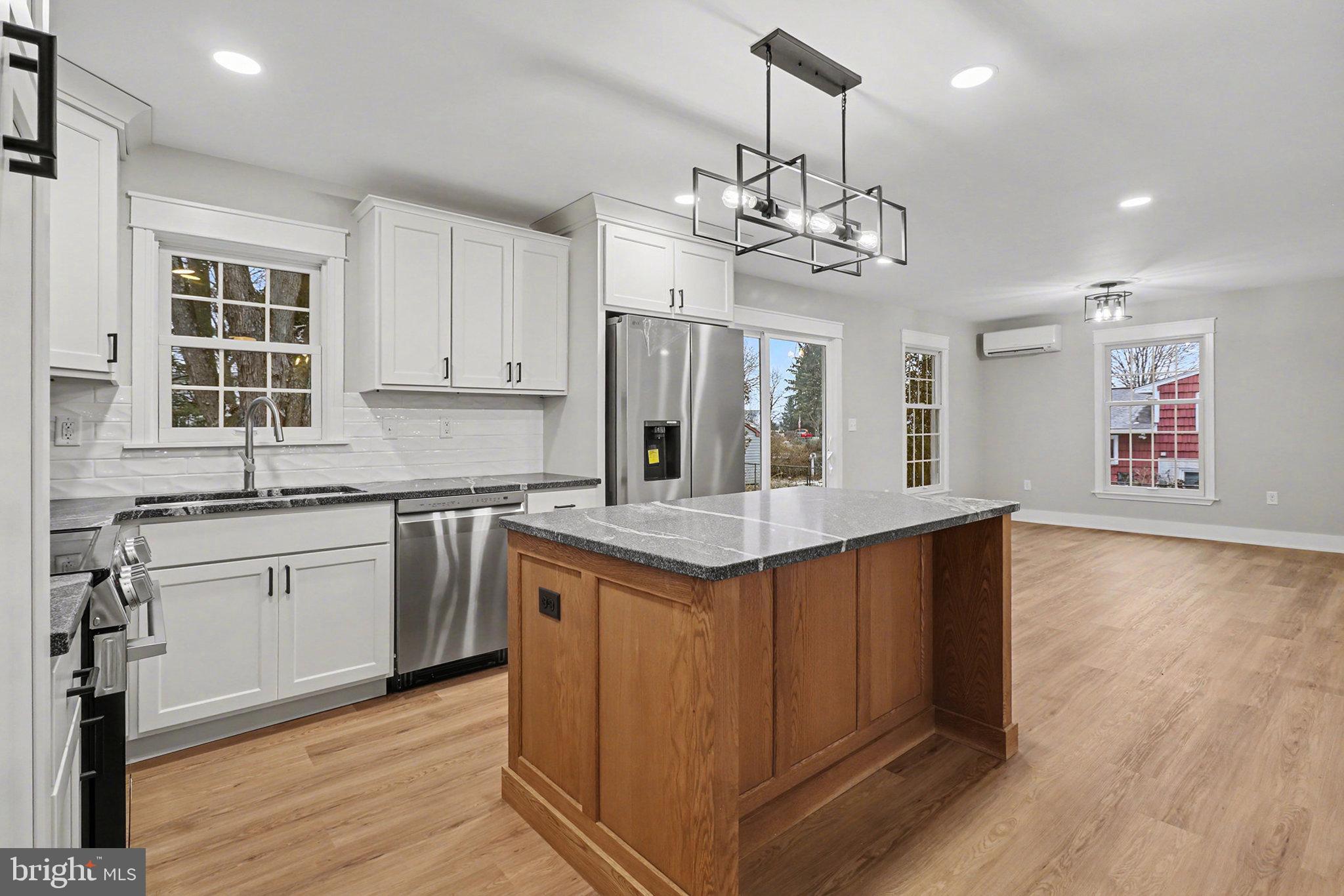 626 Sand Hill Road Hershey, PA 17033 - Photo 12 of 29 a kitchen with stainless steel appliances granite countertop a sink dishwasher a stove and a refrigerator with wooden floor