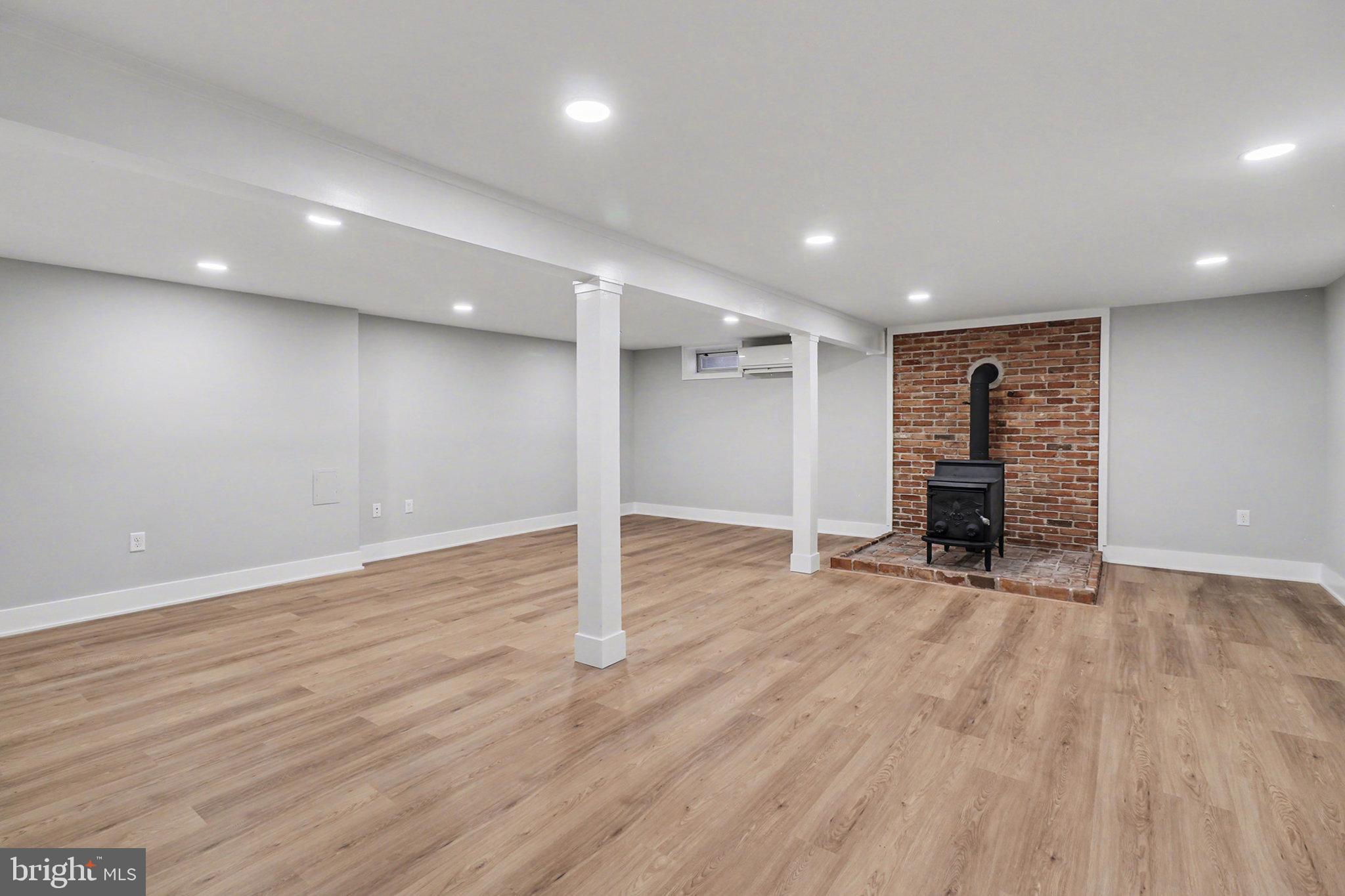 626 Sand Hill Road Hershey, PA 17033 - Photo 24 of 29 an empty room with wooden floor and fireplace