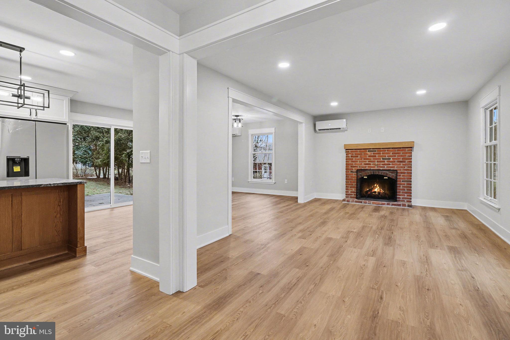 626 Sand Hill Road Hershey, PA 17033 - Photo 8 of 29 an empty room with wooden floor fireplace and windows