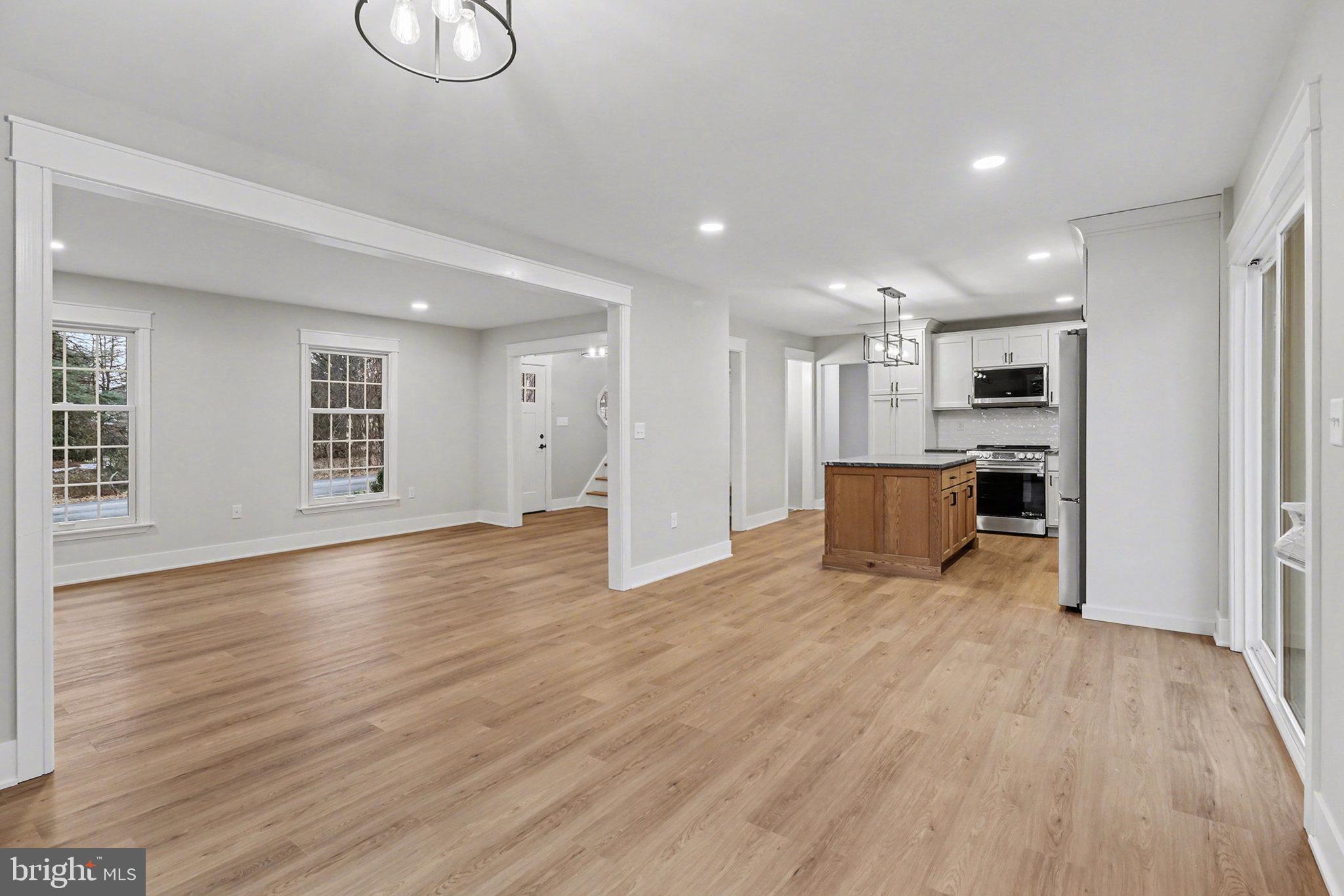 626 Sand Hill Road Hershey, PA 17033 - Photo 10 of 29 a view of empty room with wooden floor and kitchen