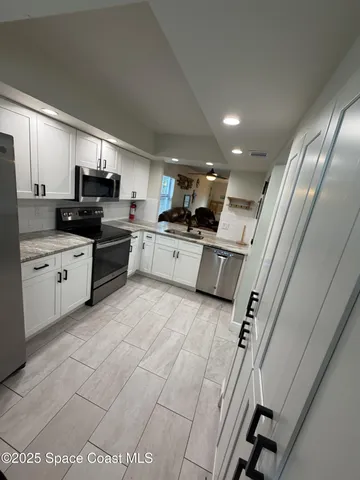 a living room with a large bed and furniture