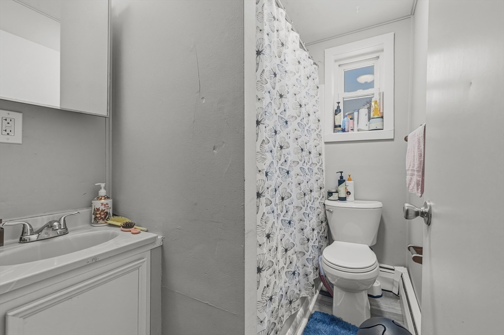 144 Choate Street Fall River, MA 02723 - Photo 14 of 42 a white toilet sitting next to a bathroom sink