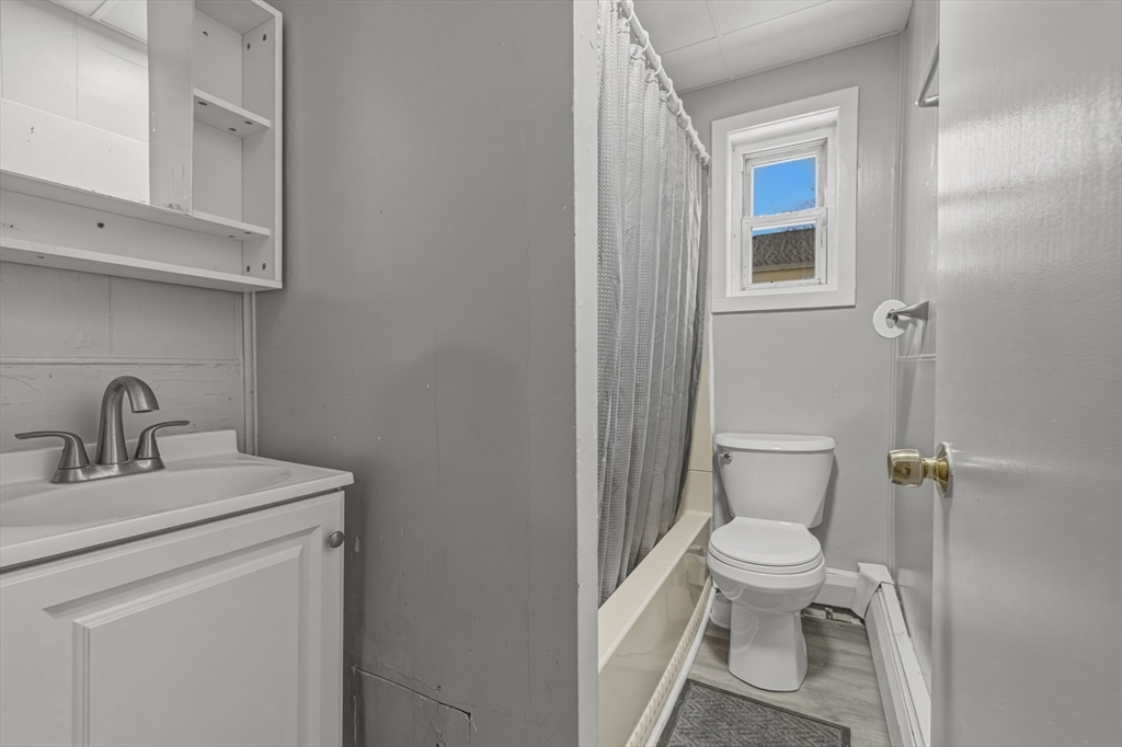 144 Choate Street Fall River, MA 02723 - Photo 29 of 42 a white toilet sitting next to a bathroom sink