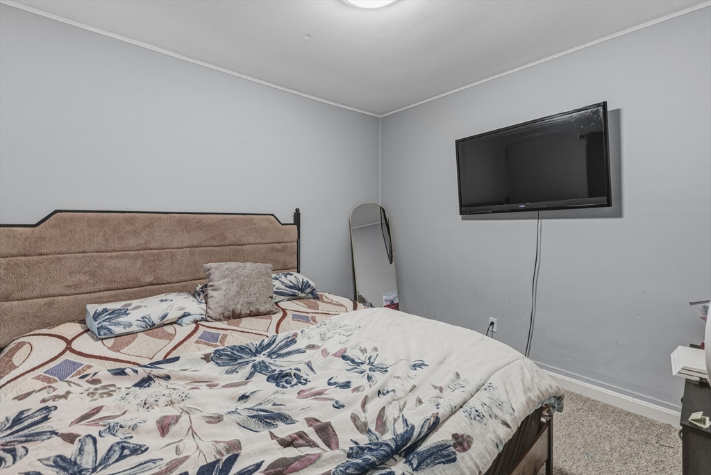 144 Choate Street Fall River, MA 02723 - Photo 33 of 42 a bedroom with a bed and a flat screen tv