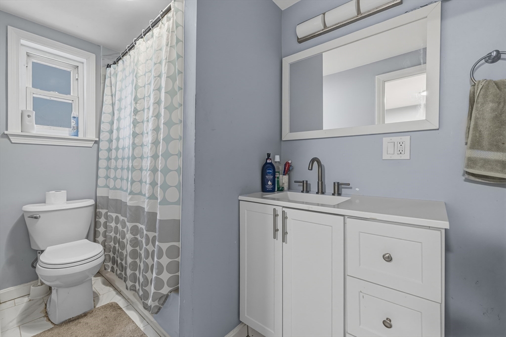 144 Choate Street Fall River, MA 02723 - Photo 34 of 42 a bathroom with a toilet sink and mirror