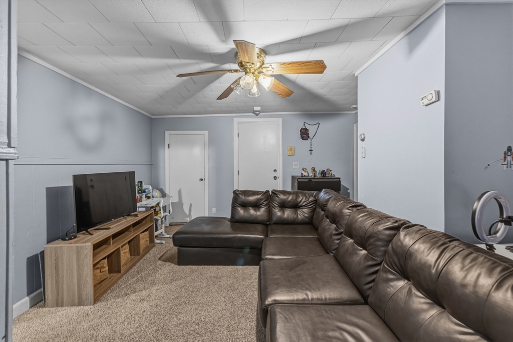 144 Choate Street Fall River, MA 02723 - Photo 38 of 42 a living room with furniture and a flat screen tv