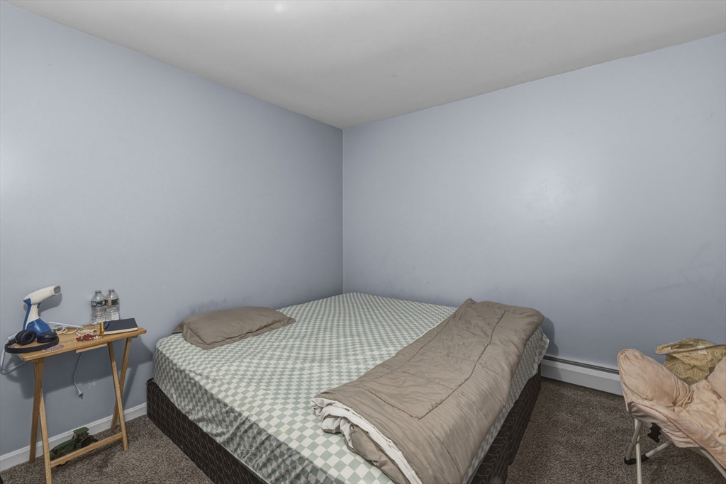 144 Choate Street Fall River, MA 02723 - Photo 39 of 42 a bedroom with a bed and chair