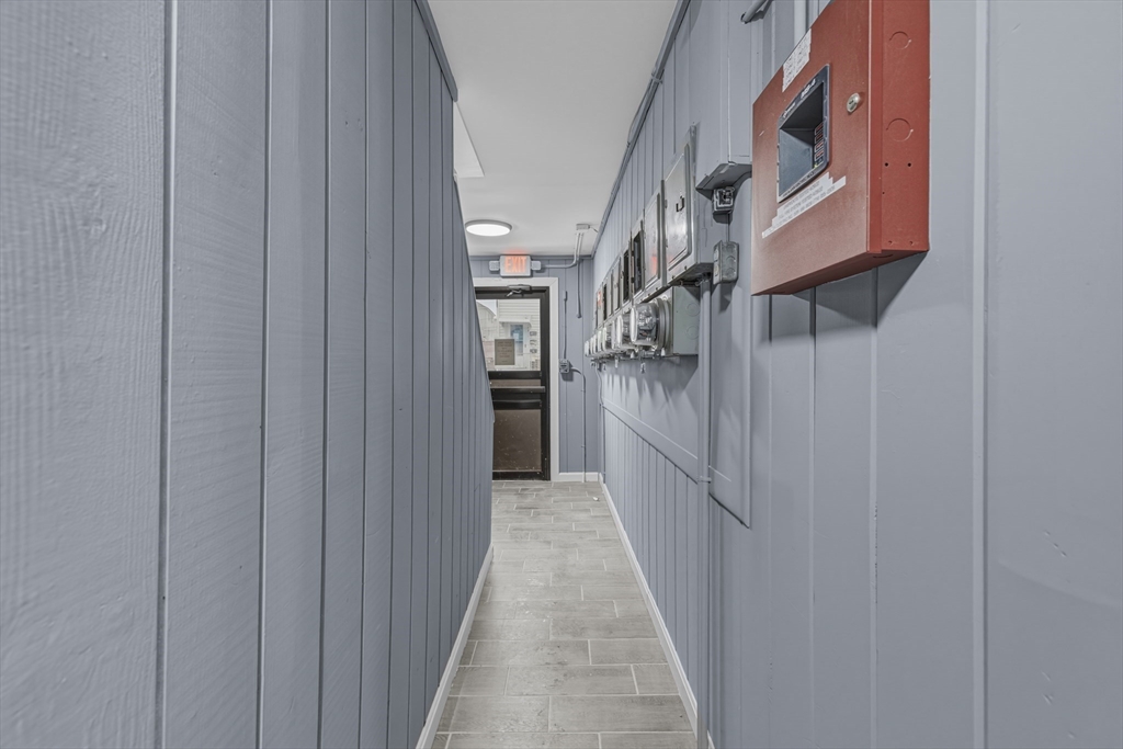 144 Choate Street Fall River, MA 02723 - Photo 9 of 42 a view of a hallway with wooden floor