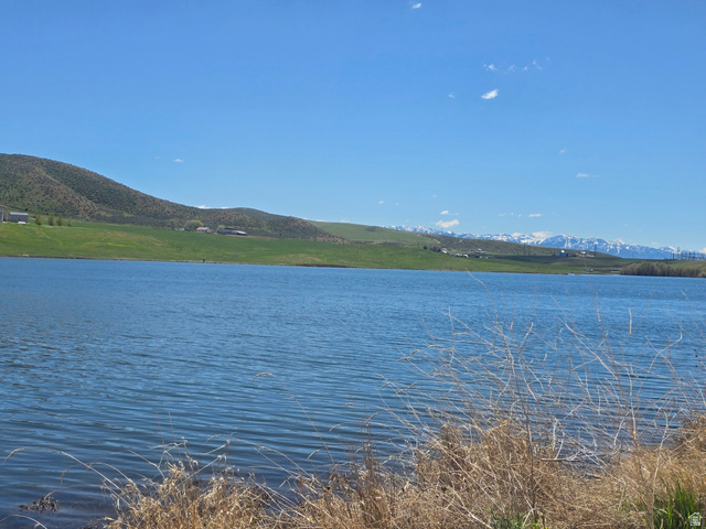 8400 North Treasurton Road, Unit CITY Preston, ID 83263 - Photo 12 of 12 Expansive waterfront property featuring a large body of water, distant green hills, and snow-capped mountains on the horizon under a clear blue sky