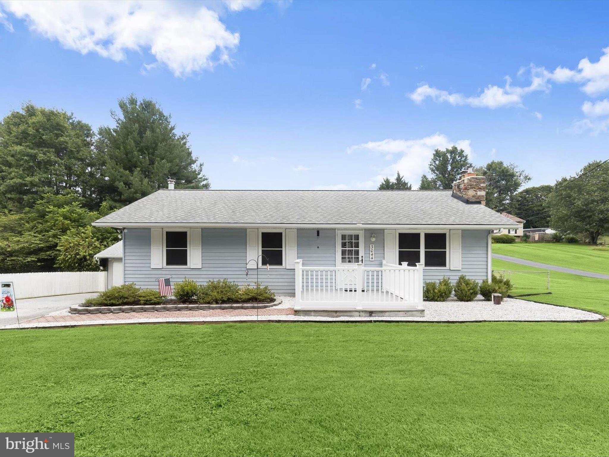 a front view of house with yard and green space