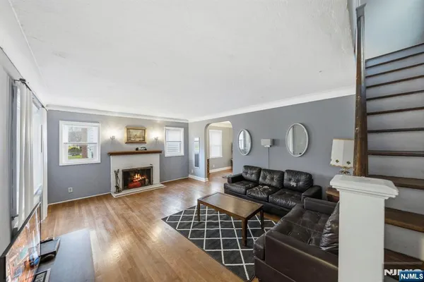 a living room with furniture a fireplace and wooden floor