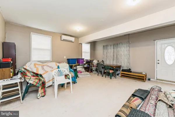a bedroom with furniture and a large window