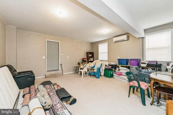 a bedroom with furniture and a large window