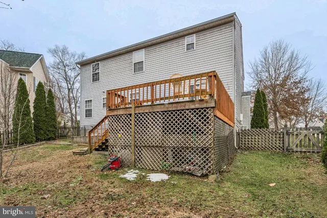 a view of a brick house with a small yard and plants