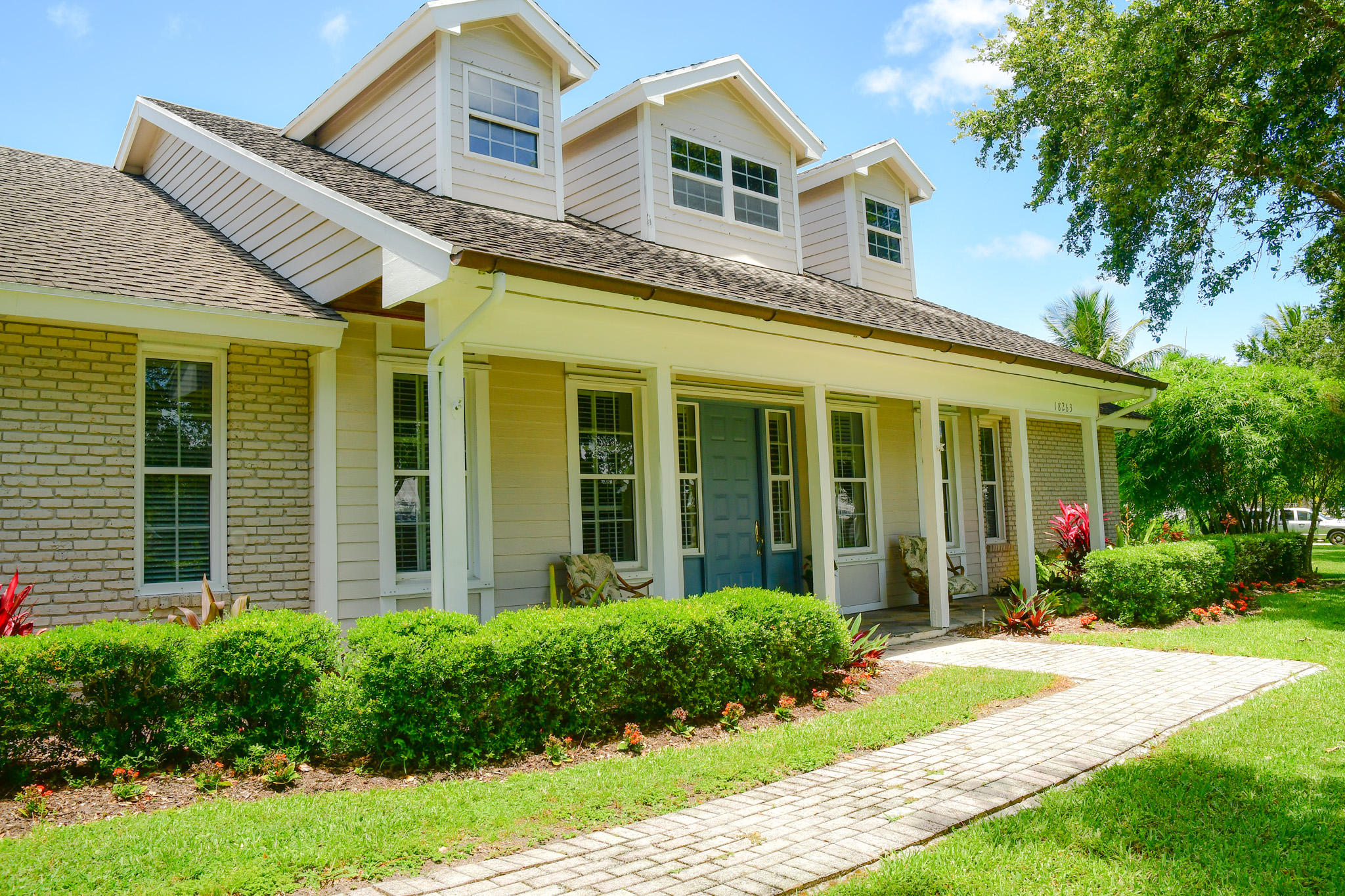18263 River Oaks Drive Jupiter, FL 33458 - Photo 2 of 24 front view of a house with a yard
