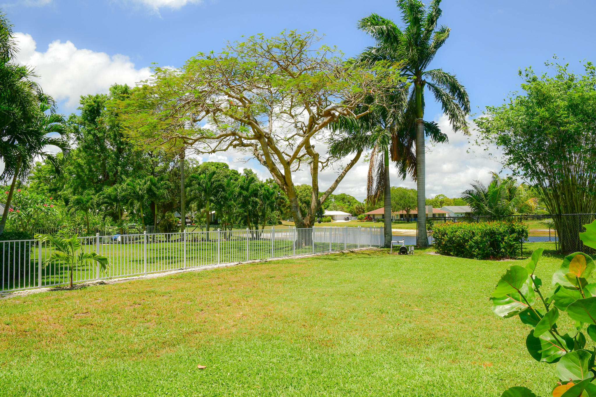 18263 River Oaks Drive Jupiter, FL 33458 - Photo 24 of 24 a view of a backyard with a garden and trees